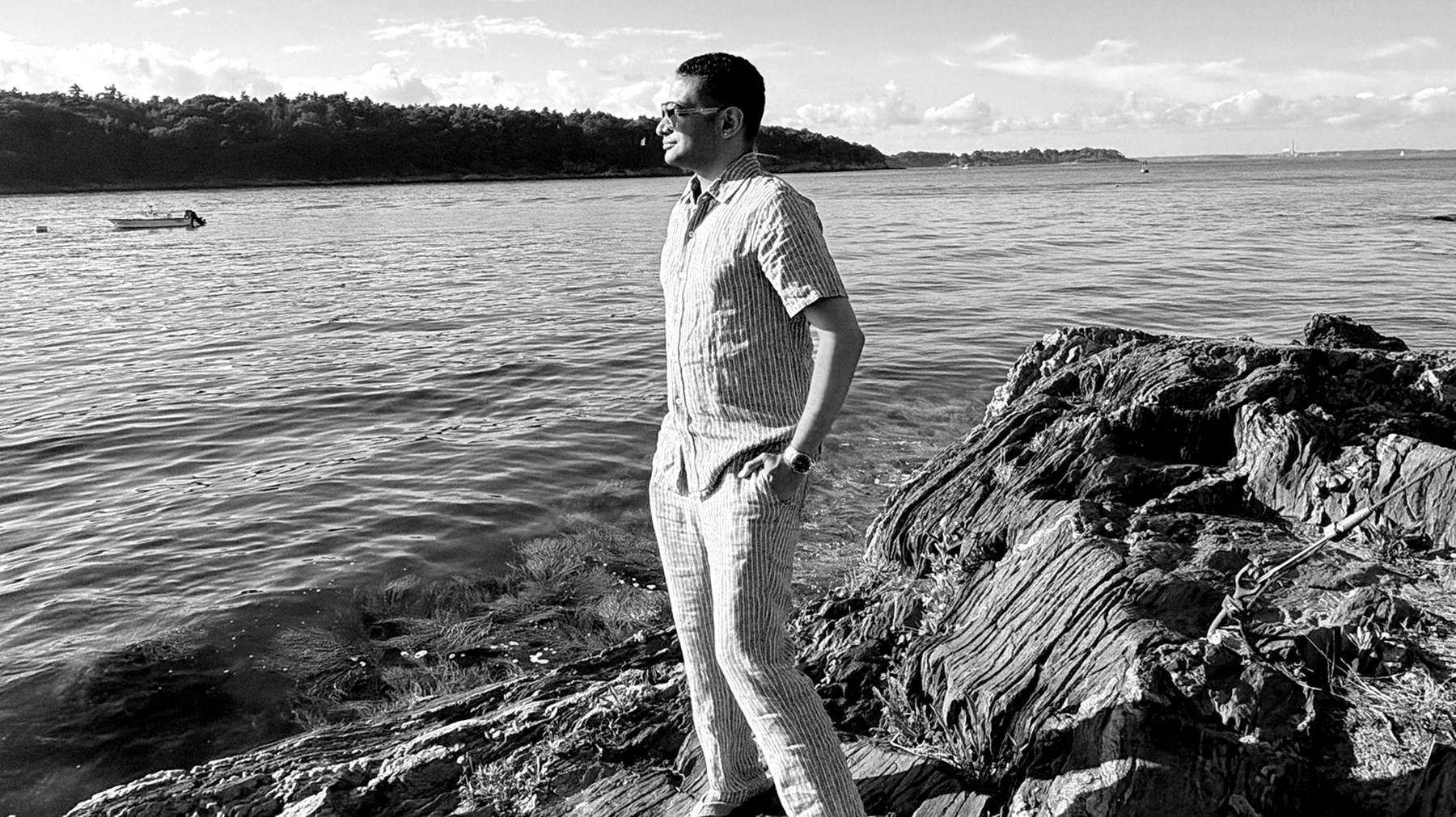 AJ Musselman standing on the rocks by the water
